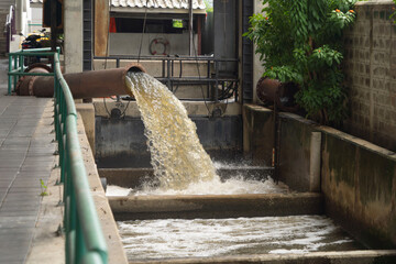 A drain pipe tube, sewage or sewage discharges waste water into a river from factory industry....