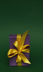 Purple box with yellow ribbon on green background.