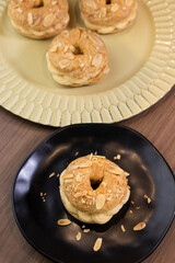 Traditional and classic dessert Paris Brest on black plate