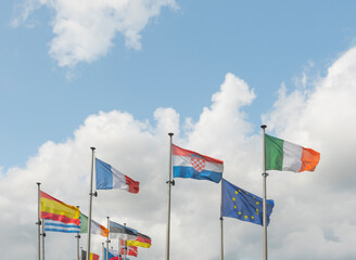 Brussels, Brussels-Capital Region, Belgium 20-08-2021. A number of flags of the European Union on a background of blue sky and clouds