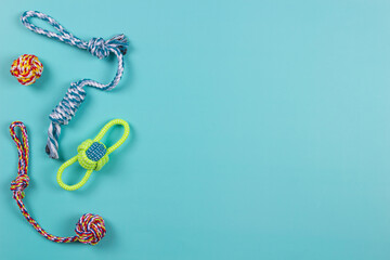 Colorful cotton rope toys for cat puppy dog on light blue background. Top view, copy space