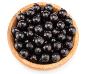 black currant in wooden bowl isolated on white background. macro. clipping path