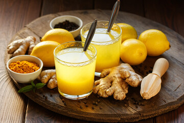 Immune booster antivirus drink, turmeric with ginger, lemon, mint and spices hot winter tea on...