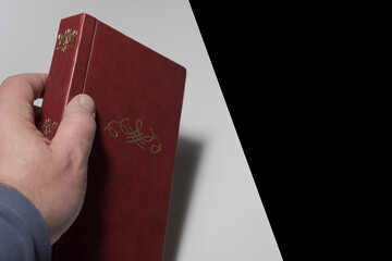Old brown book in hand with monogram Free  black space for title
