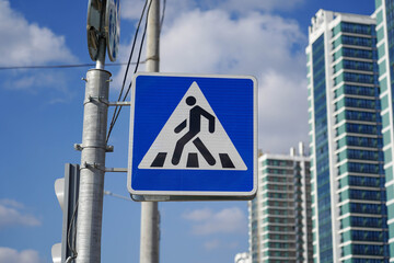 Photo of a square pedestrian crossing road sign on the street in the city