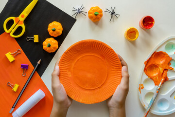 Cuts of paper for Halloween. Hand cut paper. Pumpkins. Scissors and glue. On a light background. Top view.