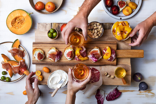 Flat-lay Of  Appetizers Table With Italian Antipasti Snacks. Family, Friends Holiday Gathering, Wine And Snacks Party. Brushetta Or Authentic Traditional Spanish Tapas Set Over Wooden Background.