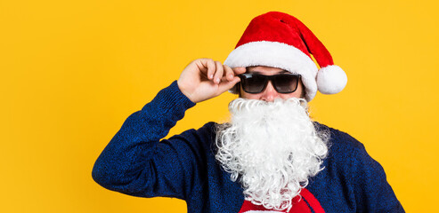 cheerful bearded man in santa claus hat and sweater. brutal hipster celebrate xmas party. winter holiday preparations. present and gift shopping sale. happy new year. merry christmas. Cheers