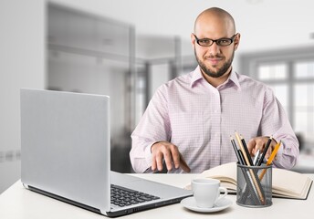 Emotional glad young employee looking at laptop screen, feeling excited