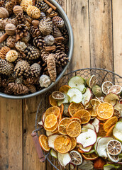 Orangenscheiben im Drahtkorb, Zapfen in Schale, natürliche und rustikale Dekoration für Weihnachten 