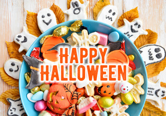 holiday Halloween candy bowl of cookies, candy, chocolates and sweets, Halloween Jack o Lantern - Trick or Treat Halloween card dark background