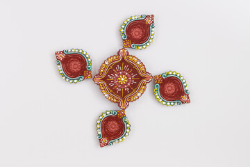 Rangoli designed using Handcrafted Eco Friendly Clay Diya Deep Dia with Marigold background with...