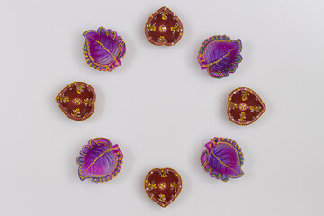 Handcrafted Eco Friendly Clay Diya Deep Dia arranged as circular rangoli background with copy space