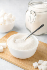 White granulated sugar and sugar cubes