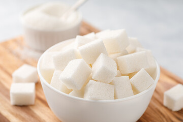 White granulated sugar and sugar cubes