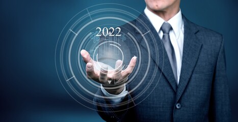 Businessman holding  growth graph a year 2022 of business and data analysis.