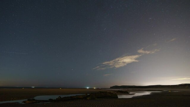 moving stars on night sky at british chanal near Calais with wreck of german ww1 submarine SM UC 61 in foreground and moving ships in background, Wissant, France