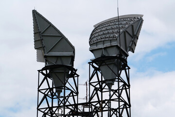 Two horn antennas of observatory, clouds background