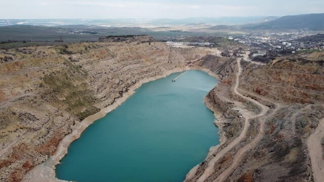 Aerial view of a lake n mountains. Stock footage. Cloudy weather. Natural background.