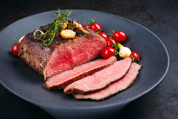 Modern style traditional Commonwealth Sunday roast with sliced cold cuts roast beef with tomatoes...