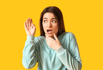 Curious woman trying to hear something on color background