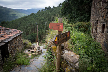 PR2 and PR5 LSA (Lousa) walking trails - wooden signpost pointing the way and distances to Talasnal Schist Village and the Castle, Lousa, Portugal