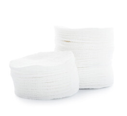 Stacks of new cotton pads on white background