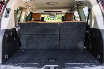 Huge, clean and empty car trunk in interior of compact suv. Rear view of a SUV car with open trunk