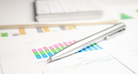 Naklejka na ściany i meble Finance analysis concept - a chart with a pen and a calculator