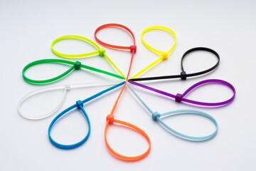 Multicolored plastic cable ties arranged in a circle, selective focus