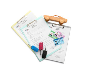 Clipboards with rental agreement, car keys, driver licenses and wooden car on white background
