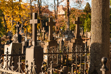 Crosses on a tombstones at a cemetery in autumn