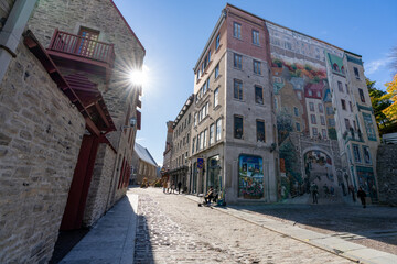 Quebec, Canada - October 20 2021 : Fresco Wall Art in the Quebec City Old Town in autumn sunny day. Mural of Quebecers.