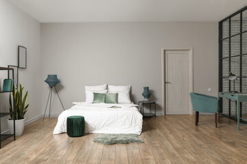 Interior of modern bedroom with green pouf