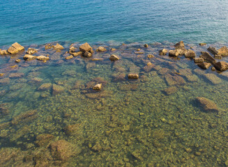 Underwater yellow brown stones, blue water and light waves see texture background. Calm meditative mood, good for wallpaper