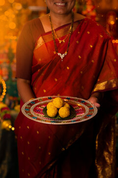 Woman holding boondi ladoo 