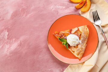 Plate with piece of tasty peach galette and ice cream on color background