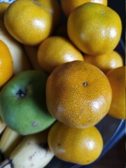 Close up view of the fruit bowl focused on mandarin orange
