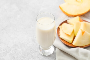 Glass of tasty melon milkshake on light background, closeup