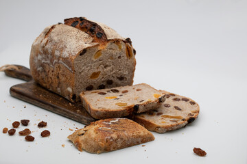 Fresh bread with candied fruits and raisins on a white background