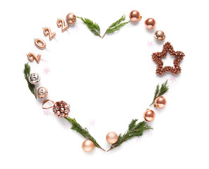 Heart made of coniferous branches and Christmas decorations and figure 2022 isolated on white background