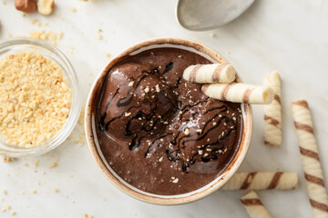 Bowl of tasty chocolate ice cream on white background