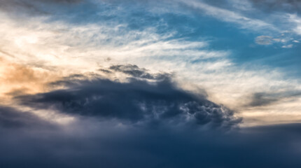View of dark cloudscape during dramatic sunset on the ocean coast. Taken in Vancouver, British Columbia, Canada.