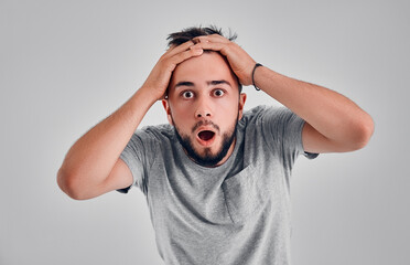 Young man in the studio on a gray background