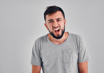 Obraz premium Young man in the studio on a gray background