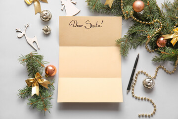 Empty letter to Santa and Christmas decor on grey background