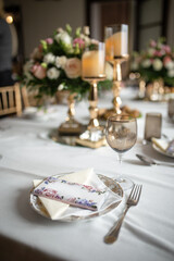 a festive table with flowers and a white tablecloth