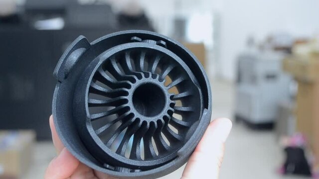 Man holding plastic model printed on powder 3d printer from polyamide powder.