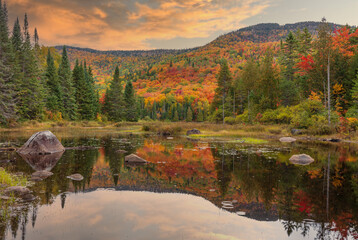 Mount Kaaikop in the background with Lac Legault showing the Autumn fall colors in the water reflection, Quebec, Canada. - 465409437