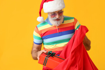 Cool Santa Claus with bag on color background